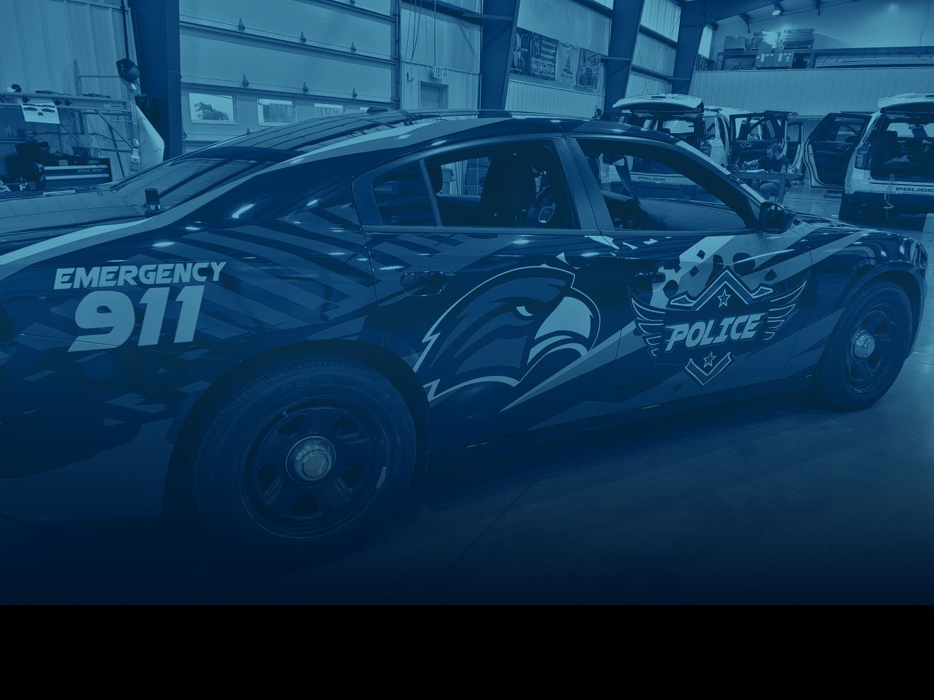 Police sedan with custom Emergency 911 and eagle graphics