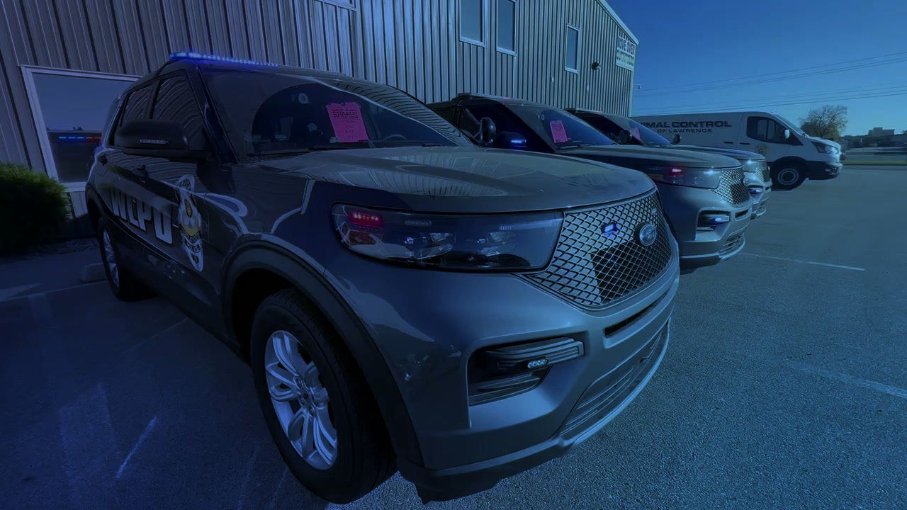 Police SUVs parked outside the shop