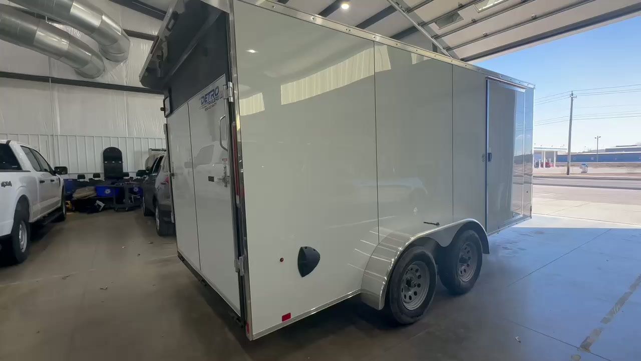 Enclosed cargo trailer inside the Move Over Outfitters shop