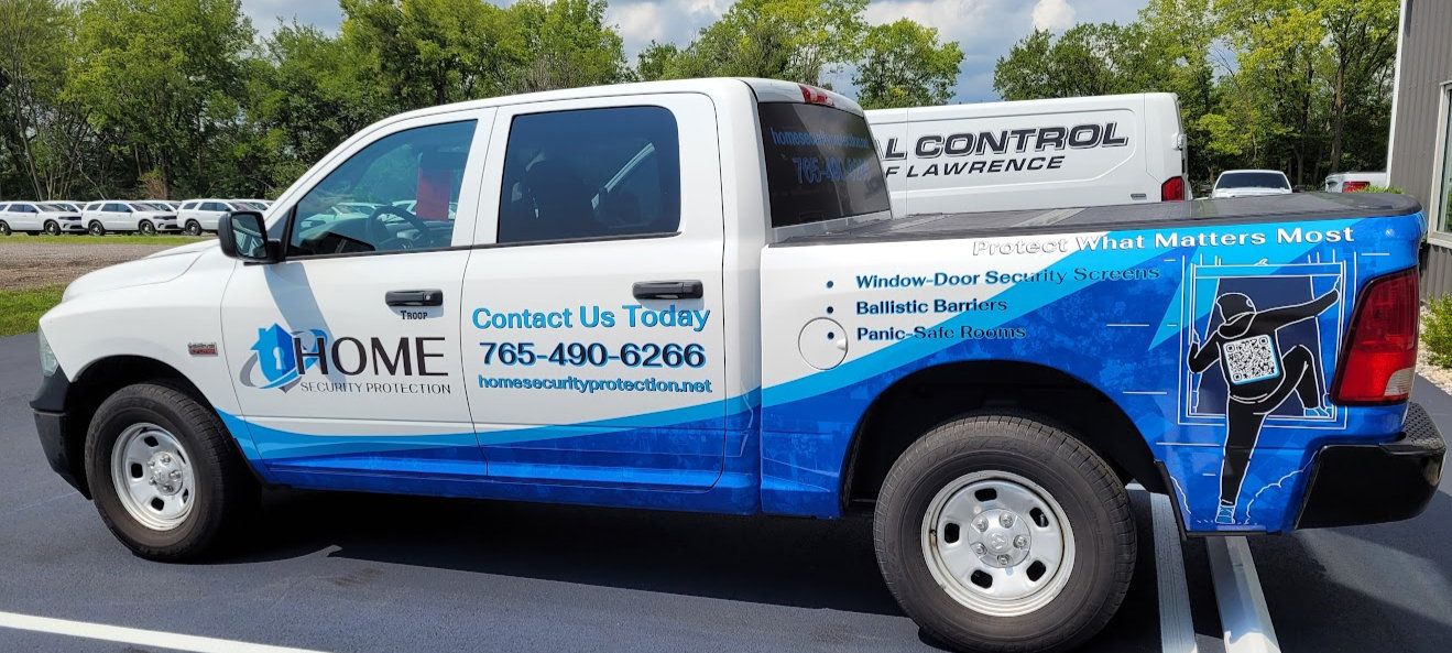 White pickup truck with blue and white company fleet graphics