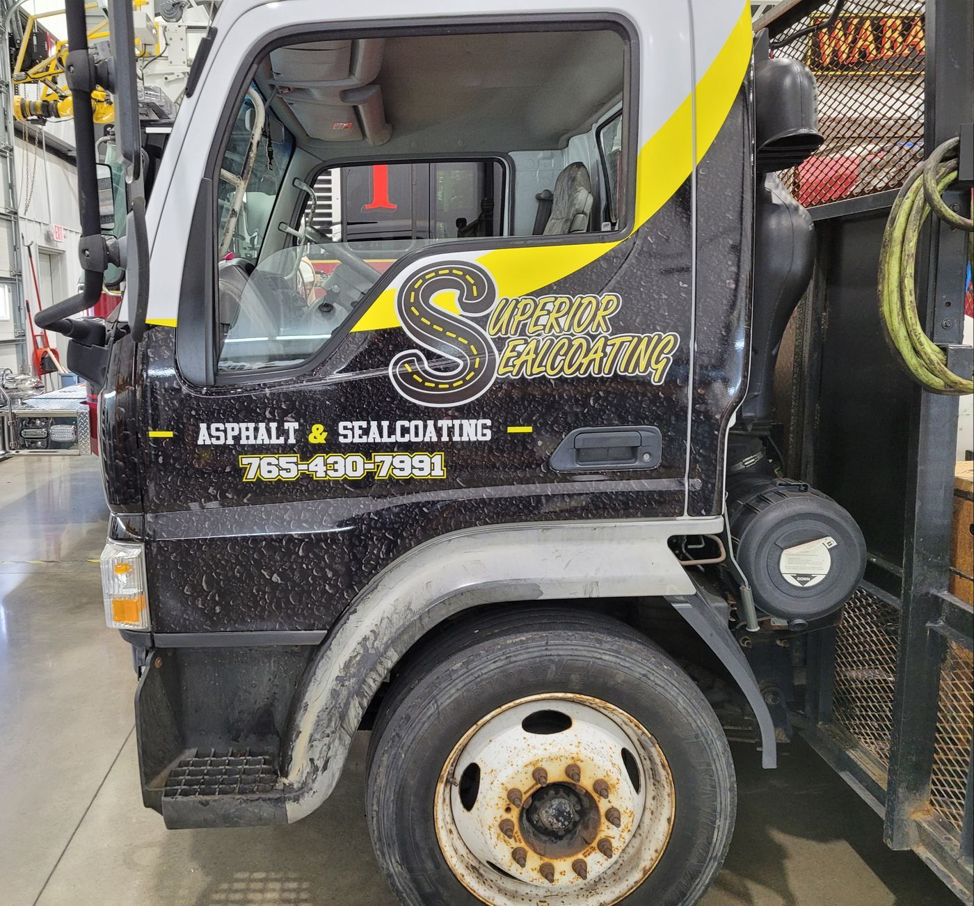 Work truck cab with yellow and black company lettering