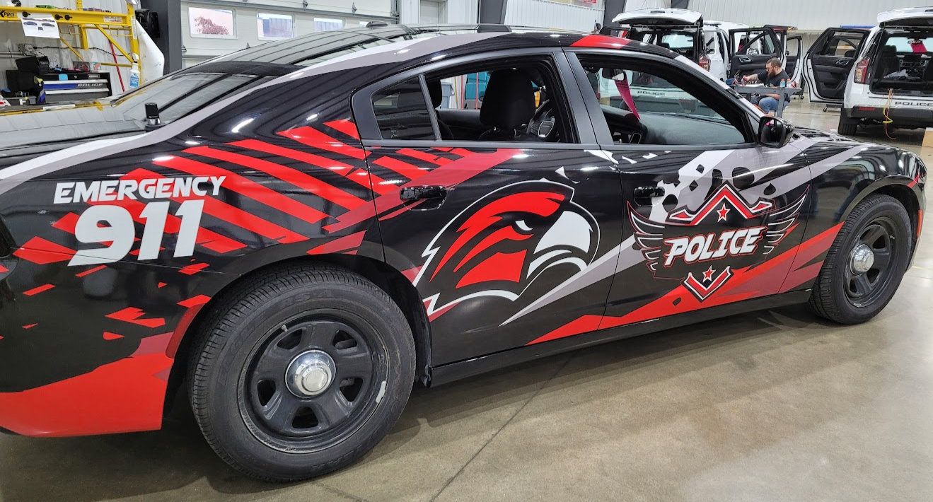 Police sedan with red, black and white custom Emergency 911 graphics