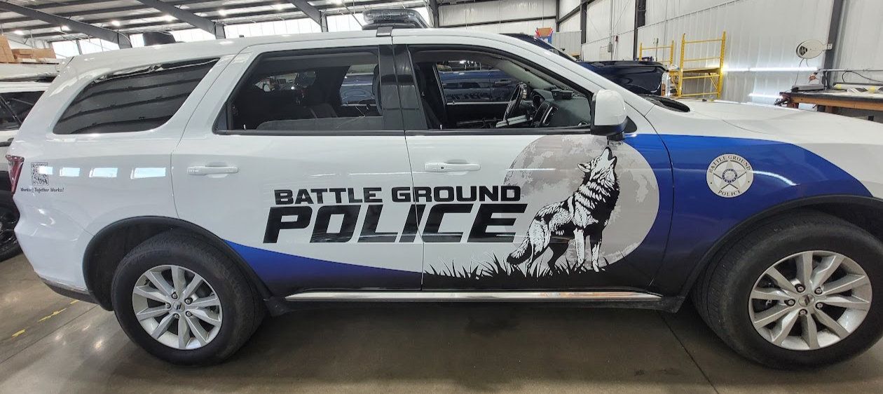 White police SUV with blue department graphics and eagle artwork